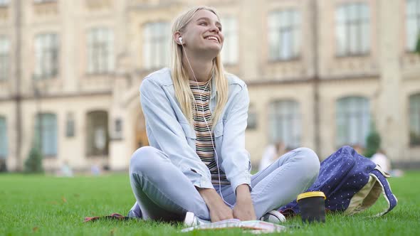 Young Woman Sitting on The Grass, Having Fun