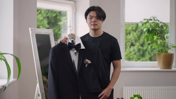 Portrait of Confident Happy Asian Young Groom Posing with Wedding Suit Indoors in the Morning alt