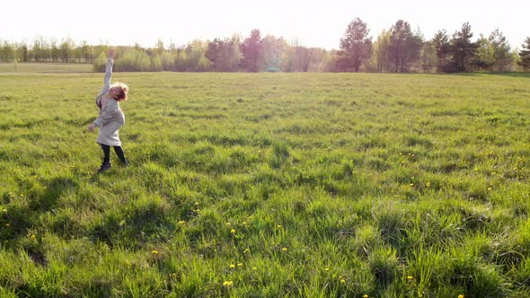 Woman Dances and Fools Around in a Green Meadow alt
