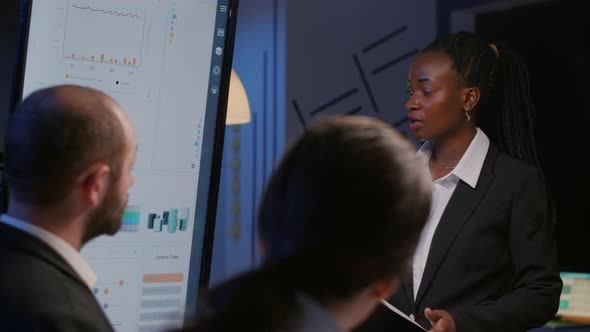 African American Businesswoman Brainstorming Financial Strategy Working Overtime alt