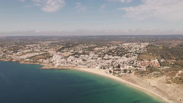High Aerial over Praia da Luz and Algarve Skyline, Portugal. Aerial alt