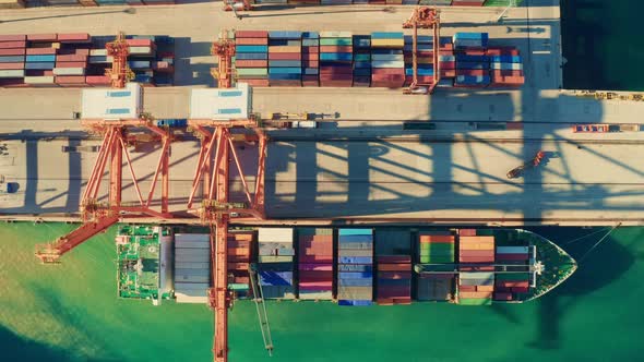 Big Portal Crane Loads Containers on Moored Ship in Port alt