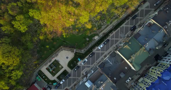 Aerial Top View Kyiv Roofs on Streets and Bald or Castle Mountain at Sunset alt