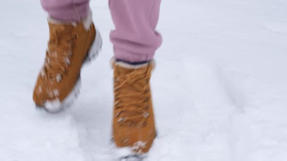 Female Legs Jumping on the White Snow