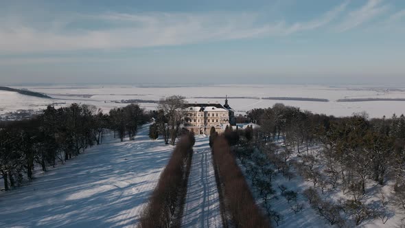 Aerial View Drone Flight Forward Over the Historic Old Castle at Sunny Winter Day Pidhirtsi Palace
