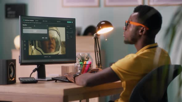 Black Man Retouching Photo on Computer alt