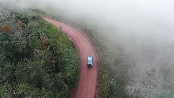 Traveling by Van Through the Foggy Jungle