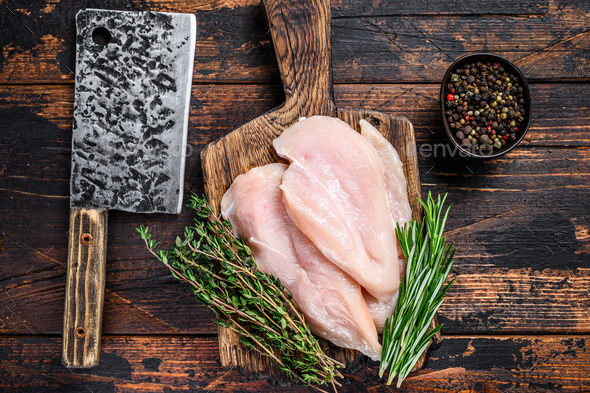 Raw Chicken Cutlets on a Cutting Board: Cutting chicken breasts