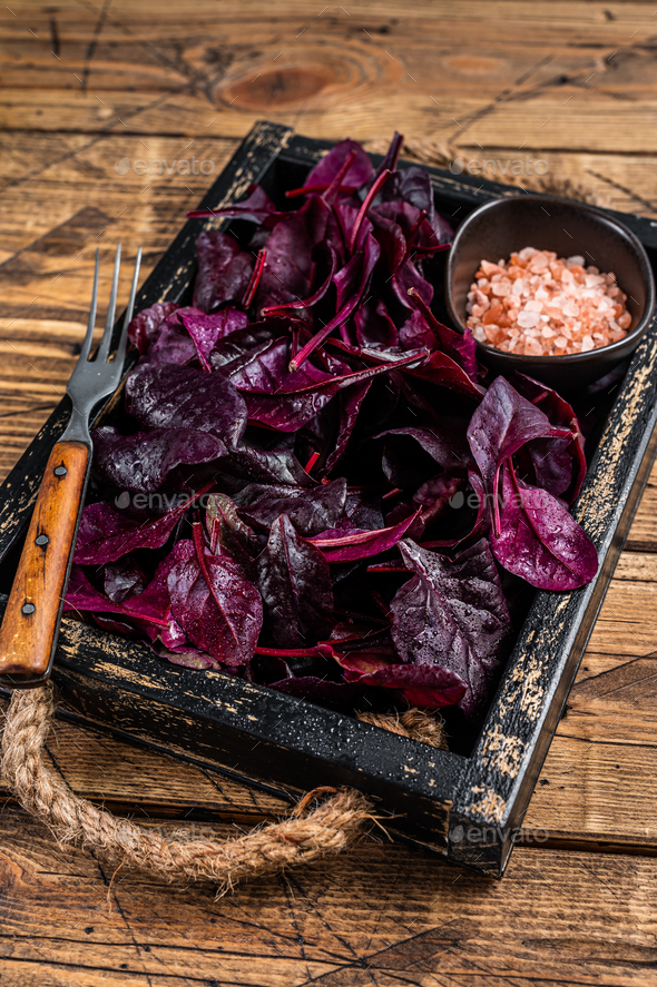 Fresh raw Swiss Ruby or red chard salad Leafs in a wooden tray. wooden background. Top view