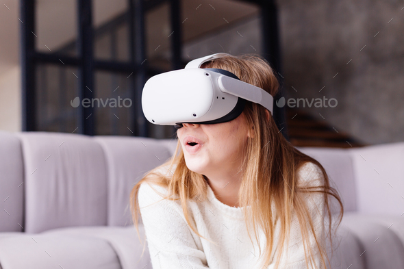 Forkert Menagerry Sommerhus Young pretty girl at home playing vr games in virtual reality glasses,  overjoyed emotional portrait Stock Photo by kroshka__nastya