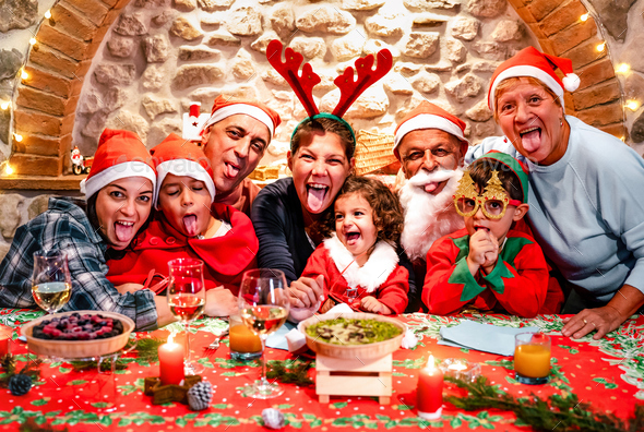 Funny selfie pic of multi generation large family with santa hats having fun at Christmas