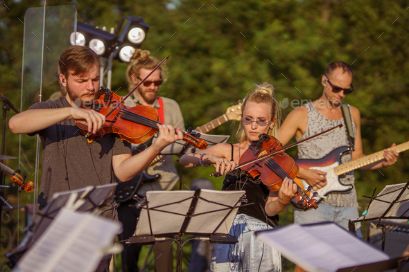 Musicians playing classic instrumental music at outdoor concert - Stock Photo - Images
