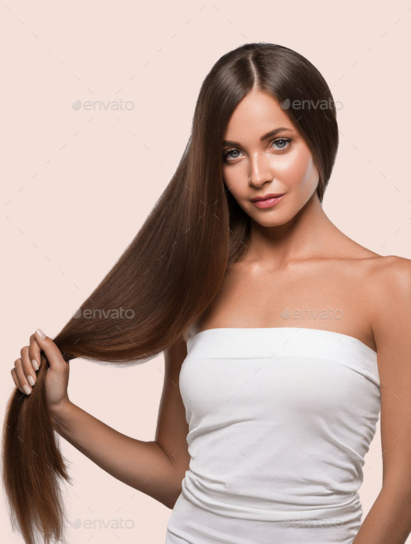 Beautiful smooth hair long brunette hairstyle woman healthy skin. Color  background. Pink Stock Photo by kiraliffe