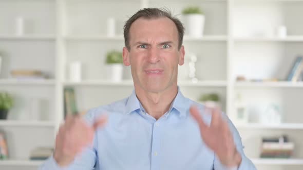 Portrait of Angry Middle Aged Businessman Screaming alt