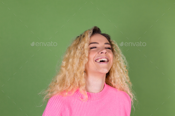 Beautiful young girl laughing. Pretty blonde with curly hair in