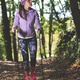 Beautiful girl during an excursion with nordic walking practice in the woods - PhotoDune Item for Sale