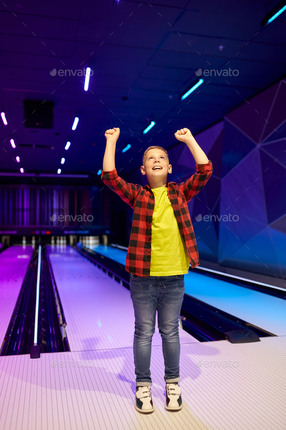 Boy playing bowling, happy little bowler