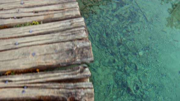 The clear water of the lake at the wooden bridge alt