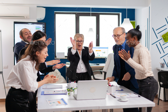 Diverse executive business team clapping in conference room