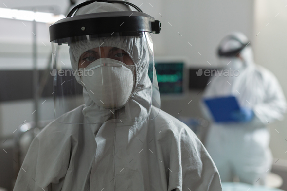Medical specialist with face mask dressed in coverall