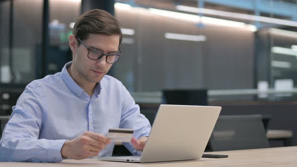 Successful Online Payment on Laptop By Young Man alt