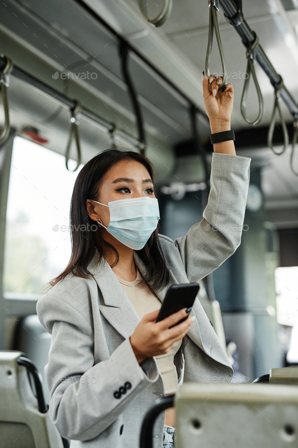 Asian Woman Wearing Mask on Public Bus