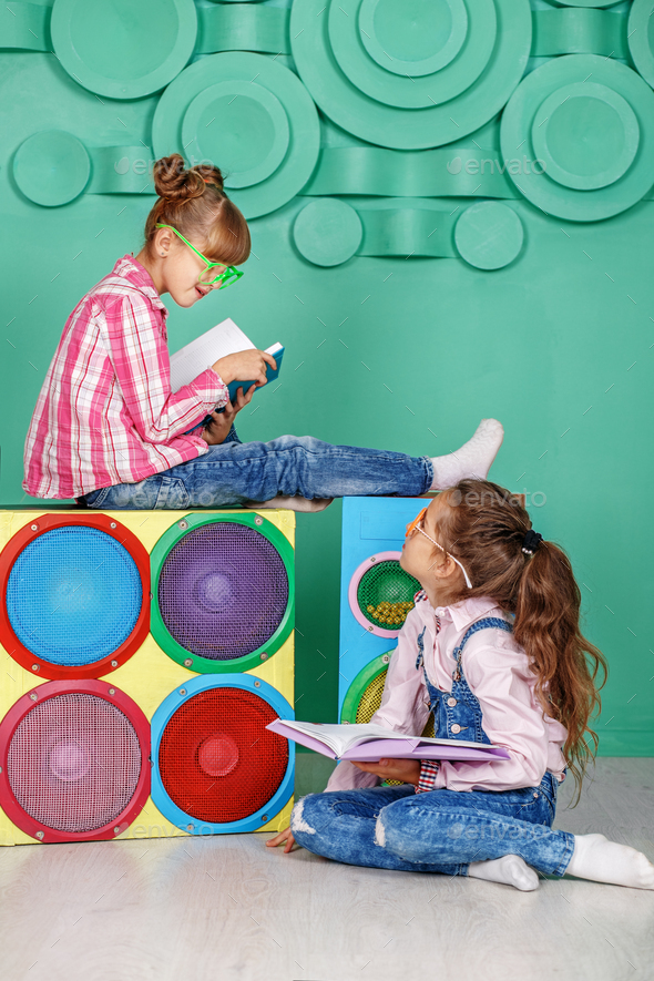 Two children read books in the room. The concept of childhood, l - Stock Photo - Images