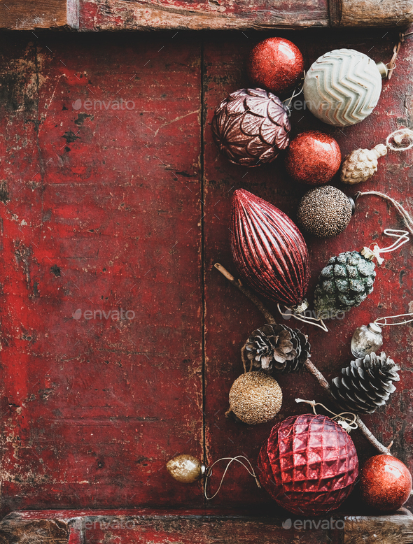 Christmas decoration toys and balls over dark red rustic wooden background - Stock Photo - Images