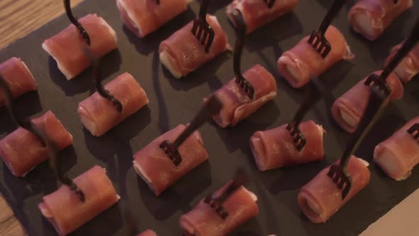 Canapes or Finger Sandwiches Along the Delicious Snacks for Guests on a Black Table