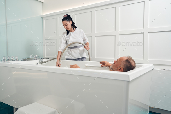 Man taking revitalizing bath in spa salon