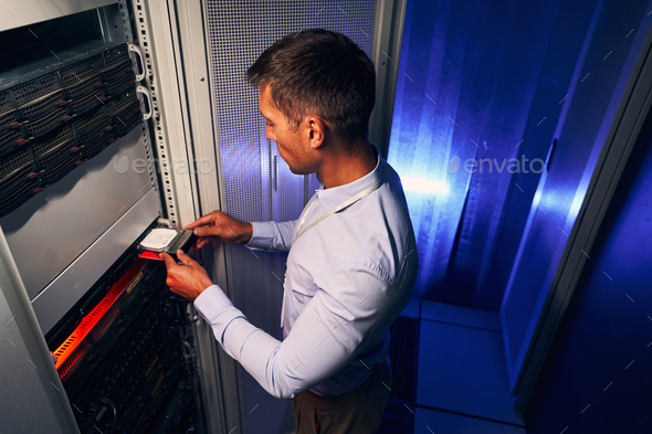 Skilled system administrator replacing old hardware component - Stock Photo - Images