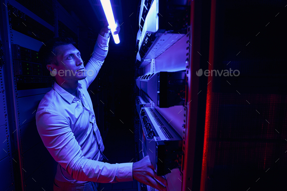 Skilled data center worker inspecting cooling system