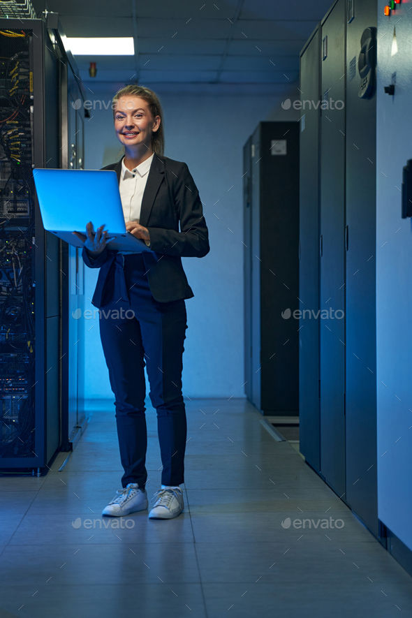 Smiling system administrator working on cyber security in data center
