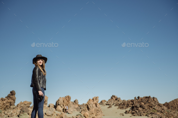 Woman with camera in desert