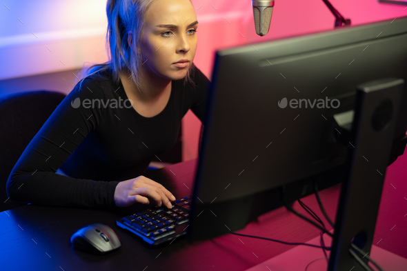 Focused Professional E-sport Gamer Girl with Headset Playing Online Video Game on PC - Stock Photo - Images