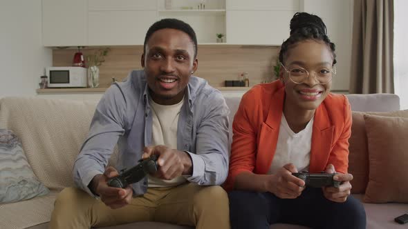 Young African American Woman Wins in a Console Game Against Her Partner alt
