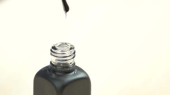 Transparent Varnish Dropping From Brush, Slow Motion. alt