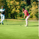 Golfing couple, putting on the green, beautiful weather - PhotoDune Item for Sale