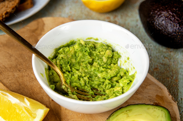 Mashed avocado in a plate with fork