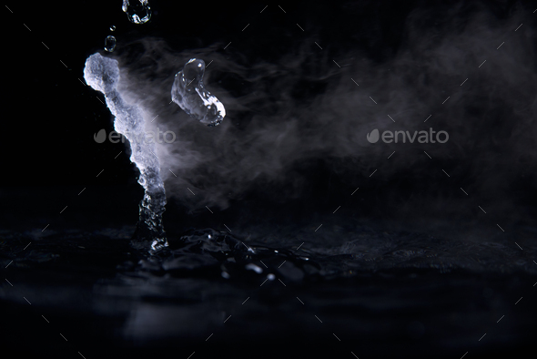 Boiling water splash with steam on black background closeup Stock Photo ...