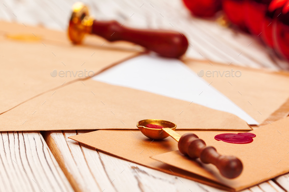 Close up of a Christmas letter with wax seal stamp on wooden table