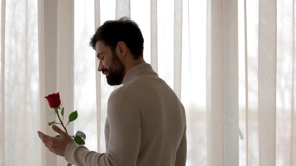 Guy Holding Flower and Phone alt