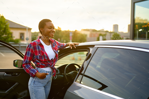 Young And Fashionable Woman Poses Outdoors With Modern Automobile Against A  Stylish Building Photo Background And Picture For Free Download - Pngtree