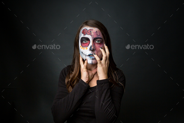 Young woman with creepy face paint