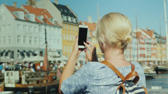 The Tourist Photographs a Canal and a Popular Tourist Street in Copenhagen Denmark alt