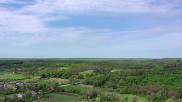 Spring forest and agricultural fields aerial view.