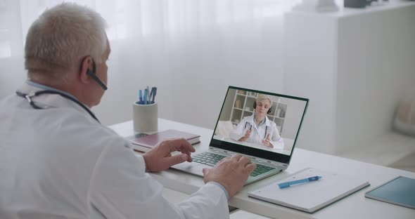 Two Doctors Are Communicating Online By Videochat, Remote Communication Technology, Distance alt