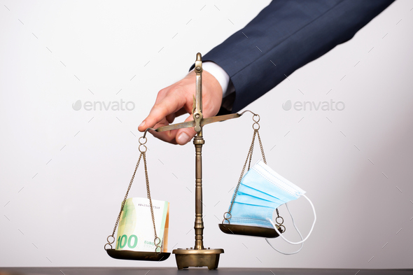 Medical mask with dollar money on scales - Stock Photo - Images