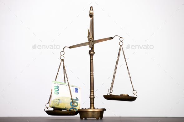 Money weighing on justice scale. Payment balance and tax - Stock Photo - Images