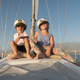 Smiling children sitting on deck of yacht in sea - PhotoDune Item for Sale